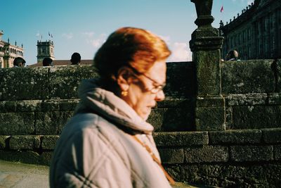 Woman standing against wall