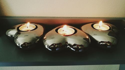 Close-up of illuminated candles on table