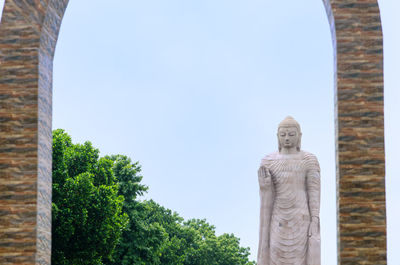 Buddha sculpture against clear sky