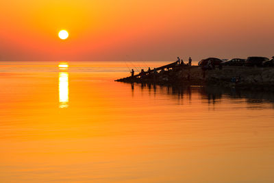 Scenic view of sea against orange sky