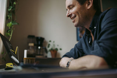 Portrait of man sitting on table