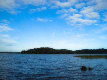 Scenic view of lake against blue sky