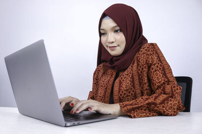 Portrait of young woman using mobile phone