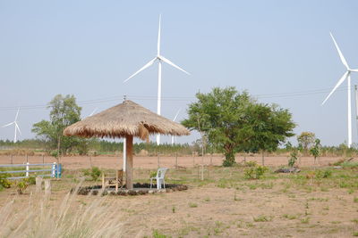 Traditional windmill on field against clear sky