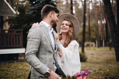 Smiling couple standing in forest