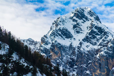 Low angle view of snowcapped mountains against sky