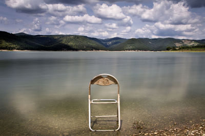 Scenic view of calm lake against mountain range