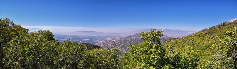 Scenic view of mountains against clear blue sky