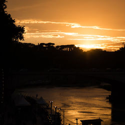 Scenic view of river at sunset