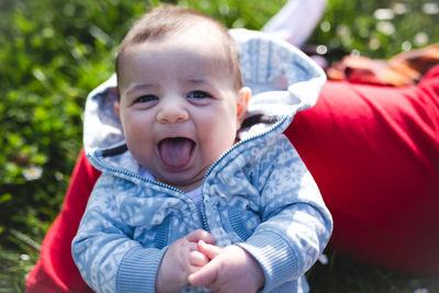 Close-up portrait of cute boy with mouth open