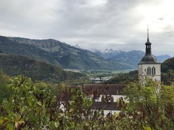 Panoramic shot of building and mountains against sky