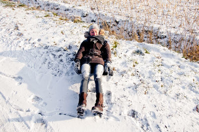 Full length portrait of young woman in snow