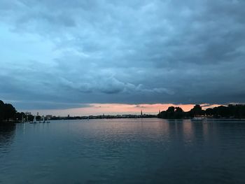 Scenic view of lake against sky at sunset