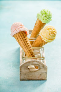 Close-up of ice cream cones in containers on table