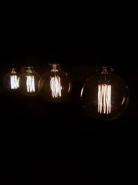 Close-up of light bulbs in dark
