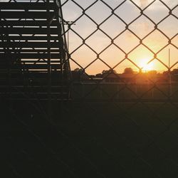 Chainlink fence at sunset