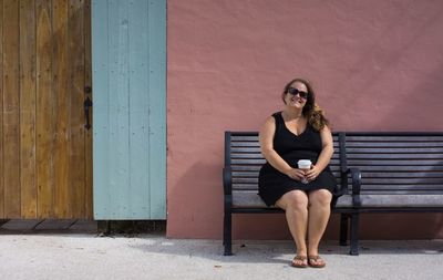 Portrait of smiling young woman sitting outdoors