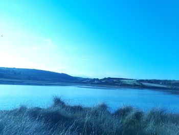 Scenic view of sea against blue sky