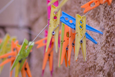 Close-up of multi colored clothespins hanging on clothesline