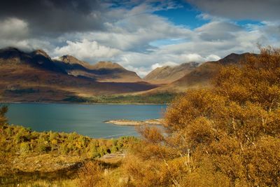 Scenic view of lake and mountains against sky