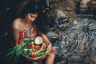 Young woman holding ice cream in basket