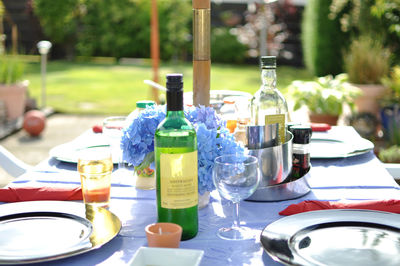 Close-up of drinks and hydrangeas on table