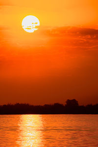 Scenic view of sea against orange sky