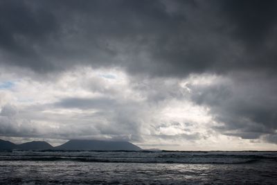 Scenic view of sea against cloudy sky