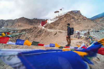 People on mountain road against sky