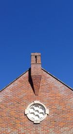 Low angle view of roof against clear blue sky