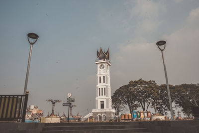 Street light by building against sky