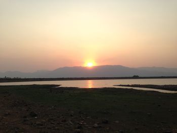 Scenic view of lake at sunset