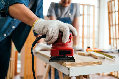 Midsection of man working in workshop