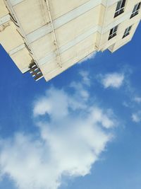 Low angle view of building against cloudy sky