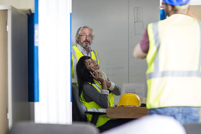 Construction worker and engineer discussing project in site office