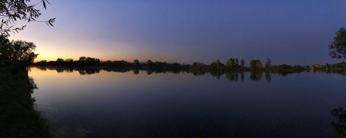 Scenic view of lake against sky at sunset