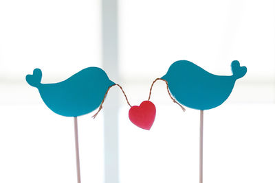 Close-up of heart shape made on white paper