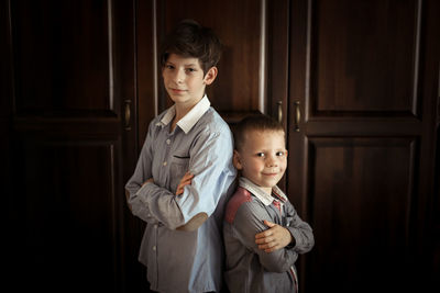 Brothers play and fight in a real interior, the concept of the opposition of siblings and family 