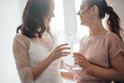 Midsection of a woman drinking water from glass