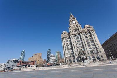 Low angle view of modern building against clear blue sky