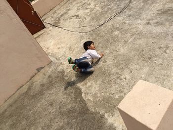 High angle view of boy playing on building terrace