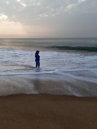 Full length of man on beach against sky