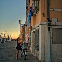 Rear view of man riding bicycle on street