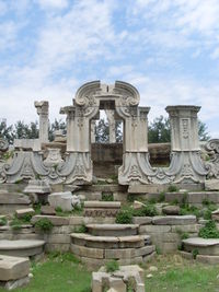 Sculpture of building against cloudy sky