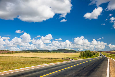 Road passing through landscape against sky