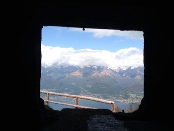 Scenic view of mountains against sky seen through window