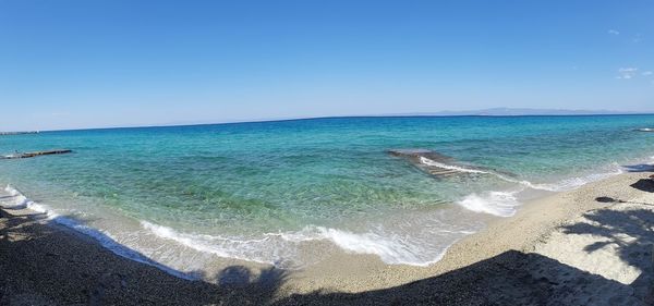 Scenic view of sea against clear blue sky