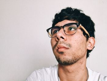 Portrait of man wearing mask against white background