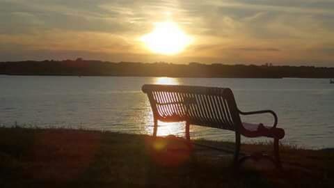 sunset, chair, tranquility, tranquil scene, water, sun, absence, scenics, sky, sunlight, empty, silhouette, lake, nature, beauty in nature, sea, reflection, idyllic, beach, orange color