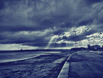 Scenic view of sea against storm clouds